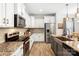 Modern kitchen features stainless steel appliances, granite countertops, ample cabinet space, and wood-look flooring at 5069 Thomasville Dr, Belmont, NC 28012