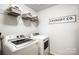 Laundry room featuring a washer, dryer, shelving, and Laundry Co. sign at 5069 Thomasville Dr, Belmont, NC 28012