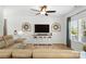 Cozy living room featuring a large window, modern ceiling fan, neutral walls, and contemporary furniture at 5069 Thomasville Dr, Belmont, NC 28012