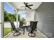 Covered patio with ceiling fan and comfortable seating for outdoor relaxation and entertaining at 5069 Thomasville Dr, Belmont, NC 28012