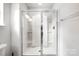 Shower featuring clear glass, white tile, and a rainfall shower head at 5069 Thomasville Dr, Belmont, NC 28012