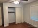 A bedroom with neutral walls, carpet floors, and a closet at 5722 Oak Dr, Charlotte, NC 28216