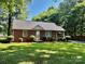 Quaint brick home with well-kept lawn, showcasing classic charm and comfort at 5722 Oak Dr, Charlotte, NC 28216