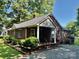 Quaint brick home with cozy porch, surrounded by meticulously maintained landscaping at 5722 Oak Dr, Charlotte, NC 28216