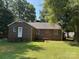 Rear exterior of a brick home with mature trees and manicured lawn at 5722 Oak Dr, Charlotte, NC 28216
