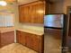Traditional kitchen featuring wooden cabinetry and stainless steel refrigerator at 5722 Oak Dr, Charlotte, NC 28216