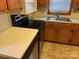 Close-up of the kitchen with stainless steel appliances and tile backsplash at 5722 Oak Dr, Charlotte, NC 28216