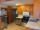 Classic kitchen with wooden cabinets and modern stainless steel appliances at 5722 Oak Dr, Charlotte, NC 28216