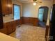 Traditional kitchen featuring wooden cabinetry and tile flooring at 5722 Oak Dr, Charlotte, NC 28216