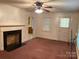 Bright living room features a fireplace and carpet at 5722 Oak Dr, Charlotte, NC 28216