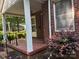 Inviting covered porch with brick flooring, ideal for enjoying the outdoors at 5722 Oak Dr, Charlotte, NC 28216