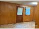 A room featuring wood paneling and a door with window at 5722 Oak Dr, Charlotte, NC 28216
