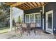 Covered back patio featuring an outdoor dining area and easy access to the backyard at 615 N Oak Dr, Huntersville, NC 28078