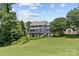 The house boasts a spacious yard perfect for enjoying outdoor activities, framed by mature trees at 615 N Oak Dr, Huntersville, NC 28078