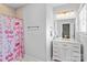 Bright bathroom featuring modern fixtures, a shower with fun curtain, and tile flooring at 615 N Oak Dr, Huntersville, NC 28078