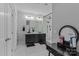 Modern bathroom with double vanity, black cabinets, white marble tile, and a glass shower at 615 N Oak Dr, Huntersville, NC 28078
