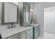 Elegant bathroom featuring dual sinks, shaker cabinets, and modern fixtures at 615 N Oak Dr, Huntersville, NC 28078