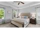 Serene bedroom with a tufted headboard, tray ceilings, and lots of natural light at 615 N Oak Dr, Huntersville, NC 28078