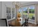 Bright dining area featuring a modern chandelier, large windows, and backyard view at 615 N Oak Dr, Huntersville, NC 28078