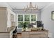 Bright home office with custom built-ins, a large desk, and natural light from the expansive window view at 615 N Oak Dr, Huntersville, NC 28078