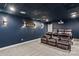 Home theater with tiered seating, a projector, and wall sconces for an immersive viewing experience at 615 N Oak Dr, Huntersville, NC 28078