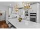 Bright kitchen featuring white cabinets, stainless appliances, a large island, and stylish gold pendant lighting at 615 N Oak Dr, Huntersville, NC 28078