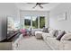 Bright and cozy living room with large windows, comfortable seating, and a TV for relaxing entertainment at 615 N Oak Dr, Huntersville, NC 28078
