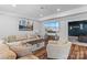 Spacious living room featuring a sectional sofa, entertainment center with large screen TV, and decorative elements at 615 N Oak Dr, Huntersville, NC 28078