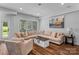 Inviting living room with a comfortable sectional sofa, stylish coffee table, and natural light from the window at 615 N Oak Dr, Huntersville, NC 28078