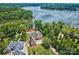 Expansive lakefront property with lush landscaping, a charming house, and sprawling greenery, offering serene waterfront living at 6216 North Rd, York, SC 29745