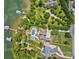Aerial view of a luxury lakefront estate with a pool, lush greenery, boat dock, and ample driveway space at 6216 North Rd, York, SC 29745