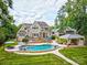 Stunning aerial view of a home with a backyard pool, pool house, and manicured lawn at 6216 North Rd, York, SC 29745