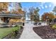 Expansive backyard with a pool, outdoor kitchen, and views of a serene lake at 6216 North Rd, York, SC 29745