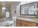 Bathroom featuring granite countertop, wooden vanity, and a glass-enclosed shower/tub combination at 6216 North Rd, York, SC 29745