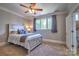 Inviting bedroom with a ceiling fan, soft carpet, and a large window for plenty of natural light at 6216 North Rd, York, SC 29745