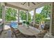 Inviting covered patio with stone floors, outdoor dining, and scenic lake views at 6216 North Rd, York, SC 29745