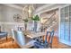This dining room features hardwood floors, a modern chandelier, and seamless entry to the stairwell at 6216 North Rd, York, SC 29745