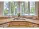 This kitchen sink features stainless fixtures, granite countertops, a window view and elegant cabinetry at 6216 North Rd, York, SC 29745