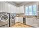 Well-equipped laundry room features modern appliances, custom cabinetry, and a built-in wine cooler at 6216 North Rd, York, SC 29745