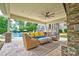 Outdoor covered patio featuring comfortable seating, a stone fireplace, and a view of the pool at 6216 North Rd, York, SC 29745