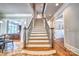 Elegant staircase with hardwood steps and wrought iron railing leads to the upper level of the home at 6216 North Rd, York, SC 29745