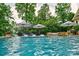 Luxurious swimming pool with lounge chairs, umbrellas, and a tranquil waterfall feature at 6216 North Rd, York, SC 29745
