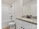 Well-lit bathroom with shower/bath combo, vanity, and granite countertops at 7008 Jerimoth Dr, Charlotte, NC 28215