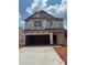New construction showing covered porch and open garage of this single Gathering home with Dryline weather barrier at 7008 Jerimoth Dr, Charlotte, NC 28215