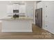 Modern kitchen with white cabinets, stainless steel appliances, and a granite countertop island at 7008 Jerimoth Dr, Charlotte, NC 28215