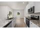 The kitchen has stainless steel appliances, white cabinets, and a granite island, perfect for cooking at 7008 Jerimoth Dr, Charlotte, NC 28215