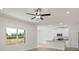 Bright living area with large windows overlooking lush greenery and an open floor plan at 7008 Jerimoth Dr, Charlotte, NC 28215