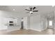 Bright, open-concept living space features hardwood floors, neutral walls, and a modern ceiling fan at 7008 Jerimoth Dr, Charlotte, NC 28215