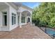 Spacious balcony with stone floors and a view of the lush backyard and pool at 7912 Baltusrol Ln, Charlotte, NC 28210