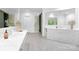 Bright bathroom featuring a large mirror, double vanity, white cabinets and tiled floor at 7912 Baltusrol Ln, Charlotte, NC 28210